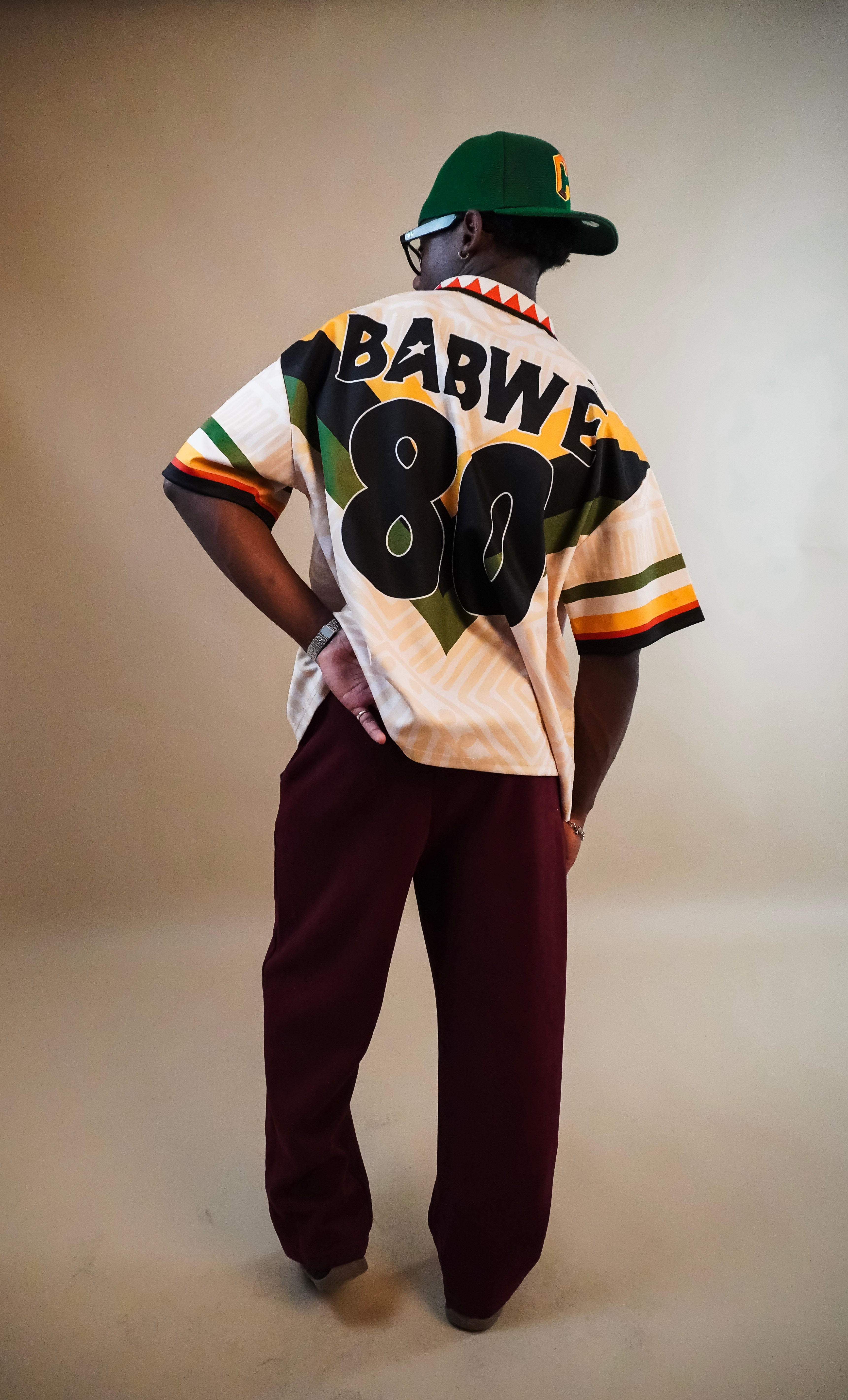Person wearing a sports jersey with 'BABWE 80' on the back, standing against a plain background.