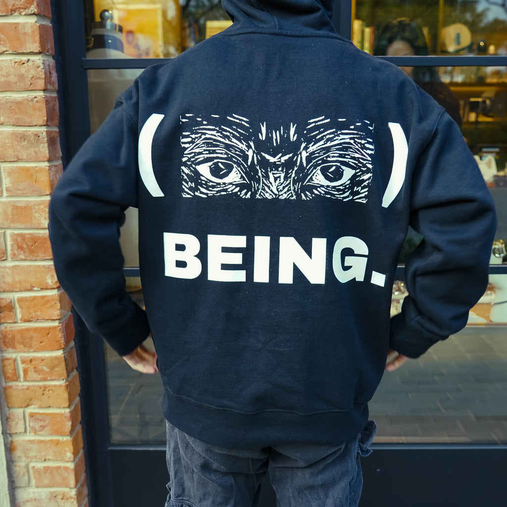 Detailed back shot of Babwê's black hoodie, showcasing the fusion of African art and contemporary fashion from Zimbabwe