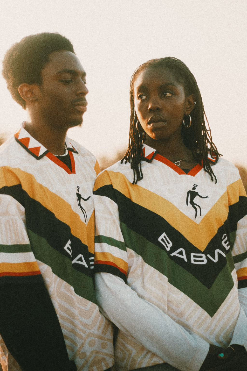 Two people wearing Babwê vintage Zimbabwe soccer jersey – nostalgic 90s design blending African streetwear with national pride.